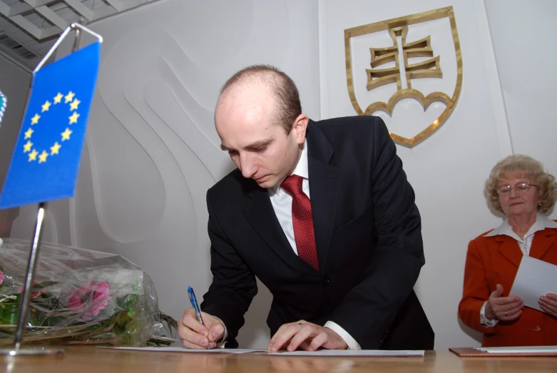 a man with a pen and note in his hand