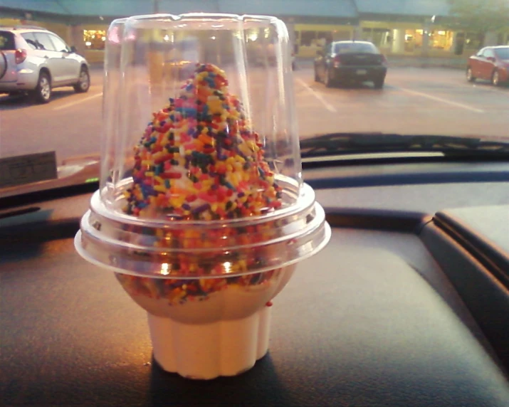there is a very large cone of doughnuts in the plastic cup