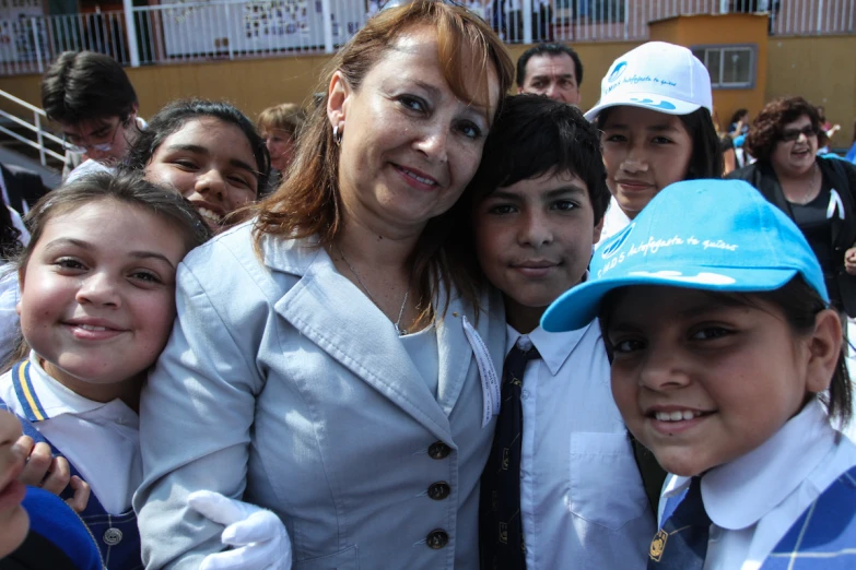 a young woman and two s smiling for the camera