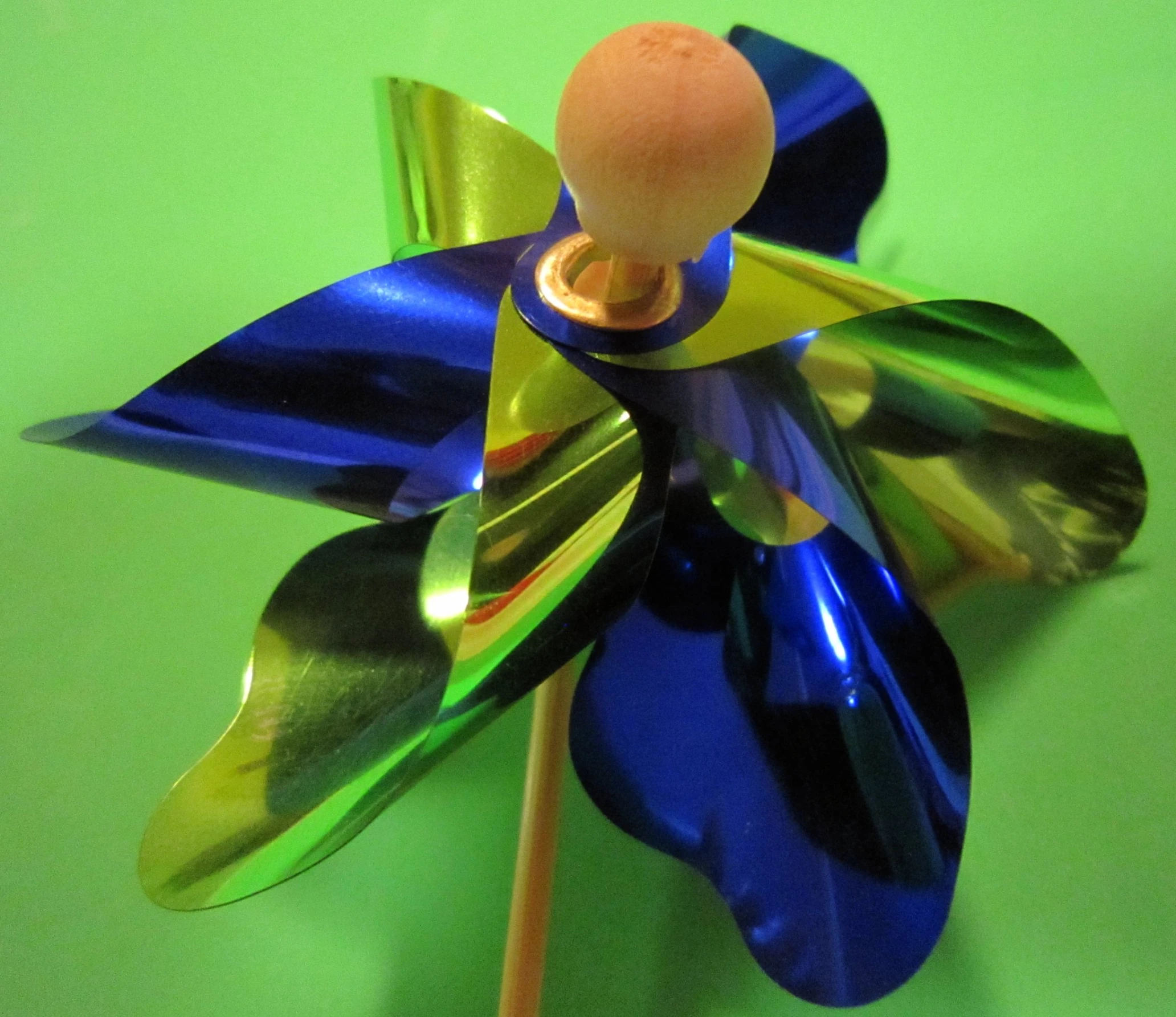 a pinwheel on top of blue and green ribboned paper