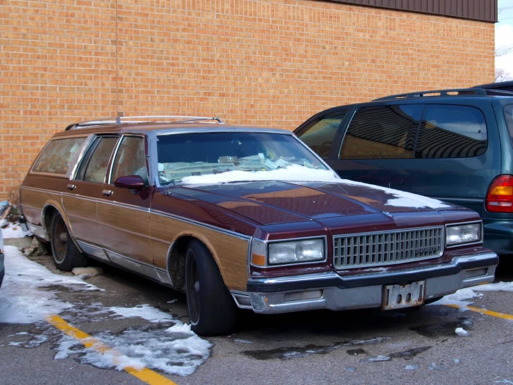 a brown car parked next to a blue van