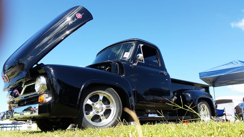 classic black truck with open trunk and flat fender