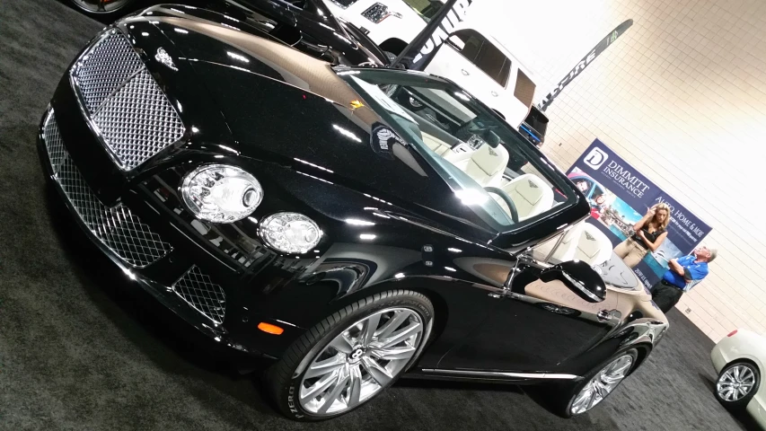 this is a black convertible convertible car parked at a showroom