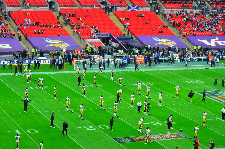 a football game being played at the stadium with many fans