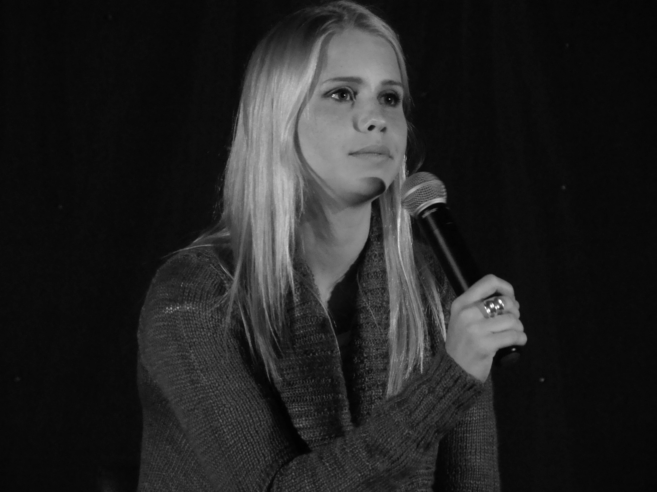 a black and white po of a woman in a microphone