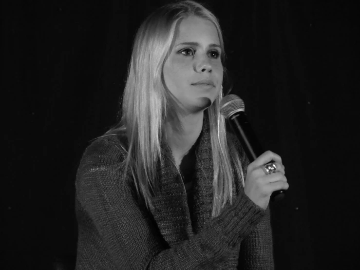 a black and white po of a woman in a microphone