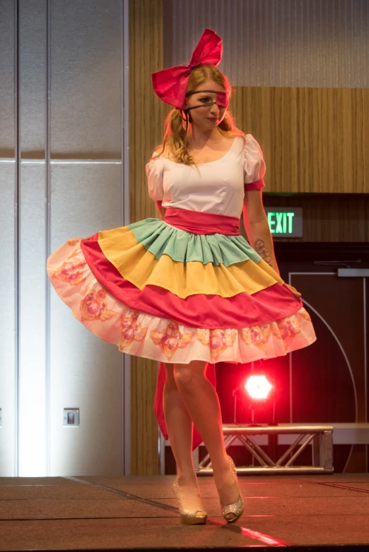 a woman in colorful skirt talking on cell phone