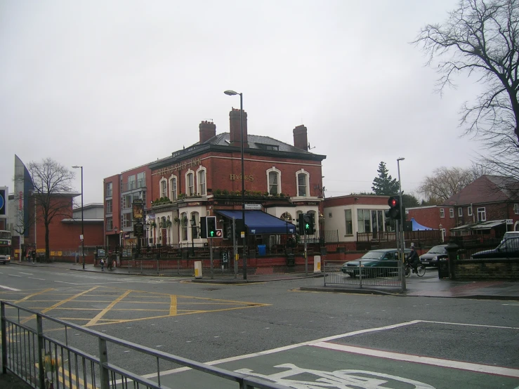 an old, red brick building with blue awning