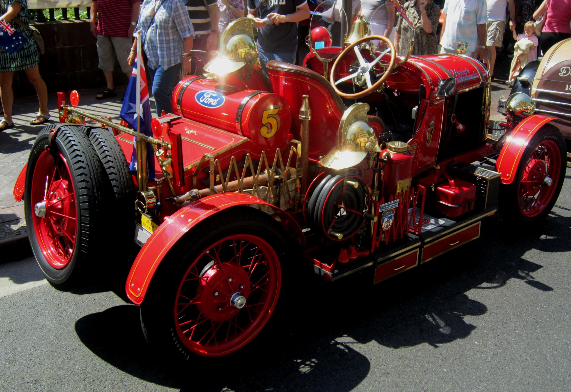 a vintage fire truck on display with other antique cars