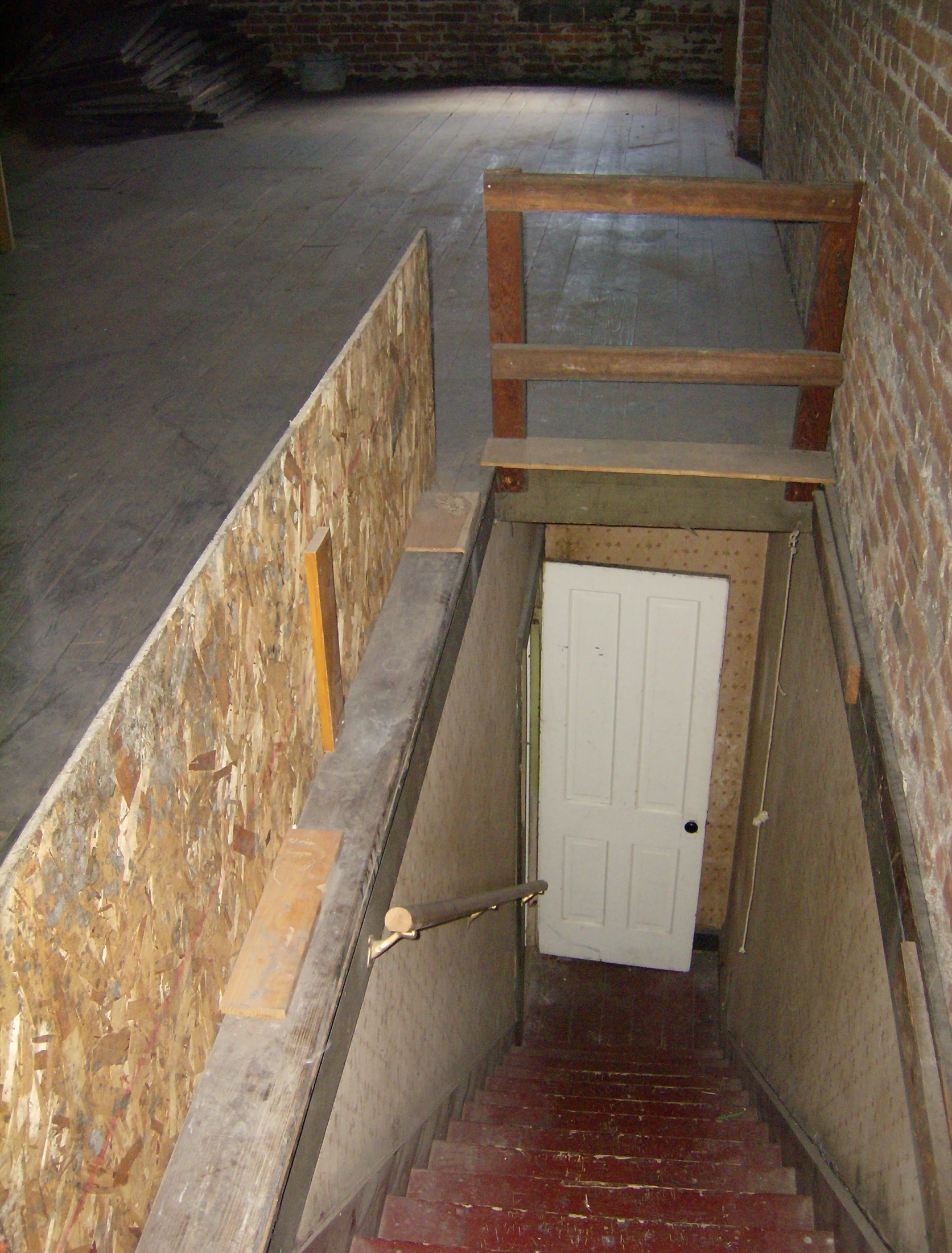 a white door in the corner of a stairwell