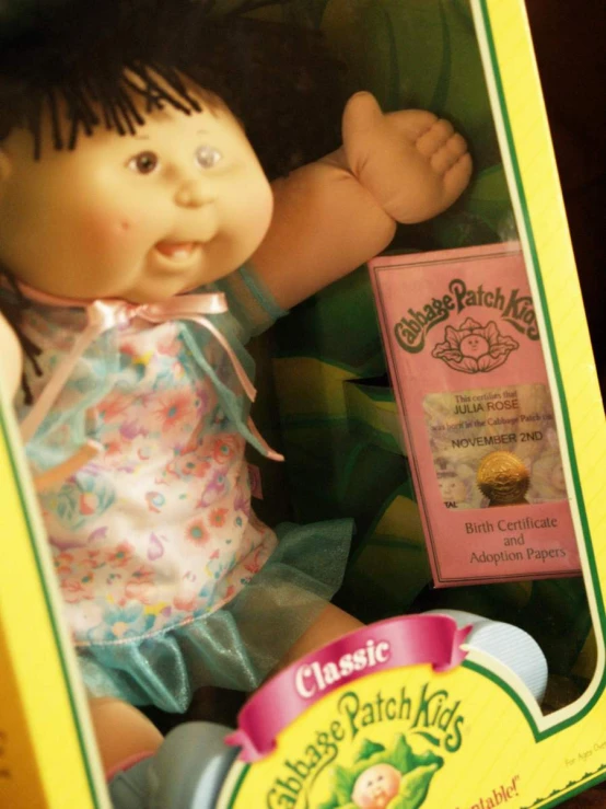 a small doll in a yellow plastic case