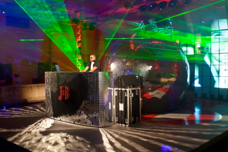 a dj playing on the stage at a party