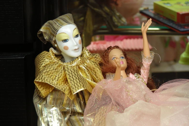 two dolls dressed as princesses next to each other