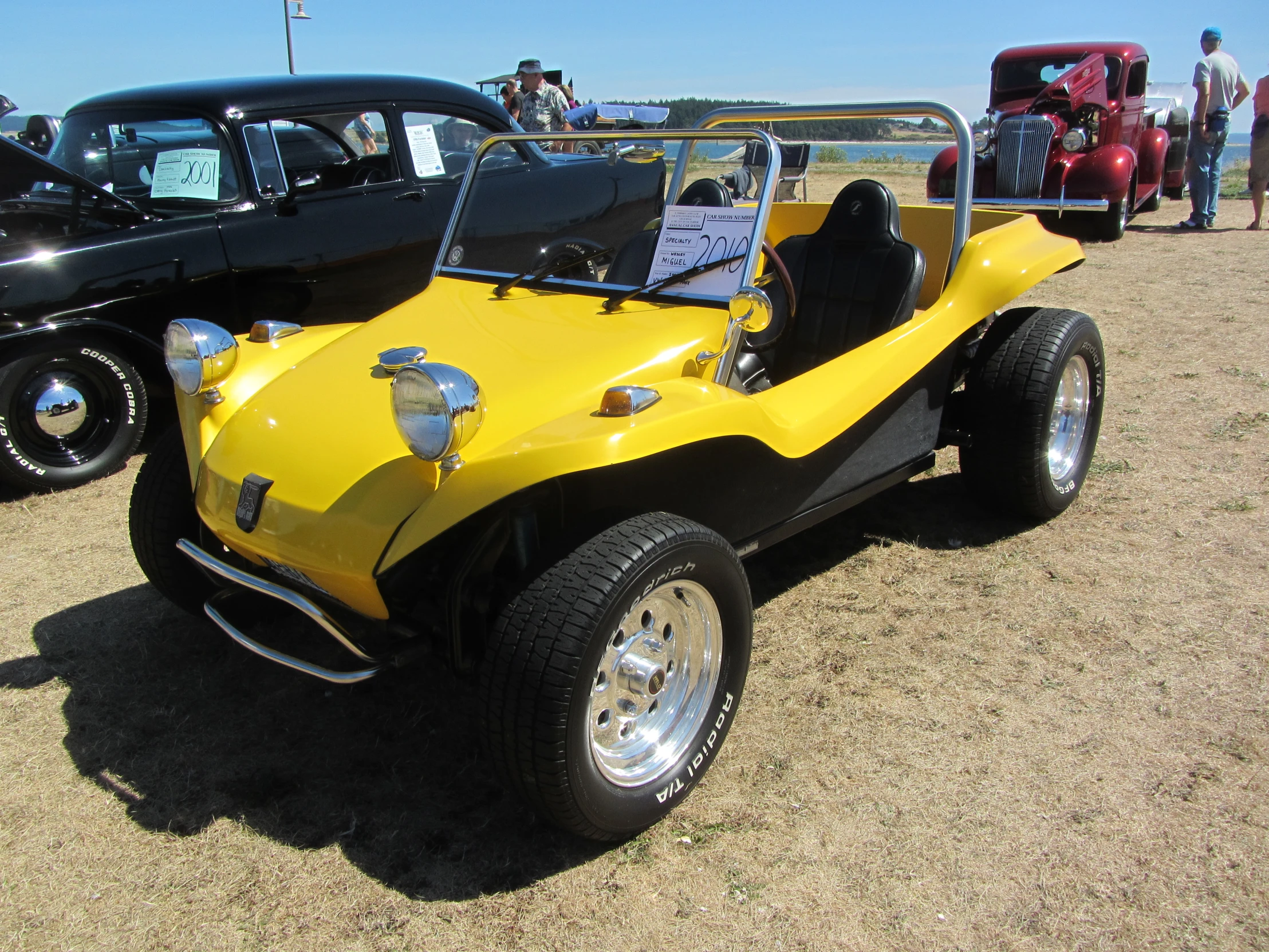 a yellow car parked next to a black car