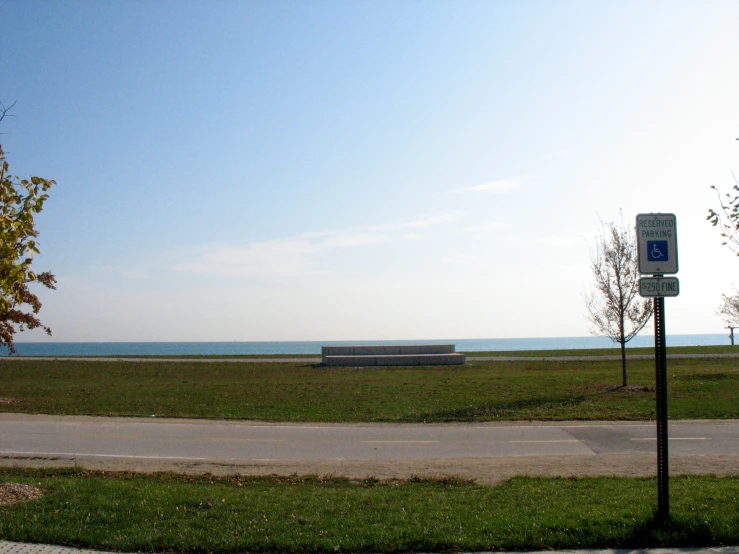 bench by a empty path by the water