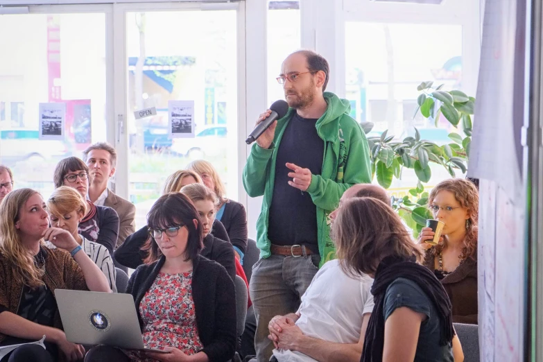 an image of a man with laptops in front of a crowd