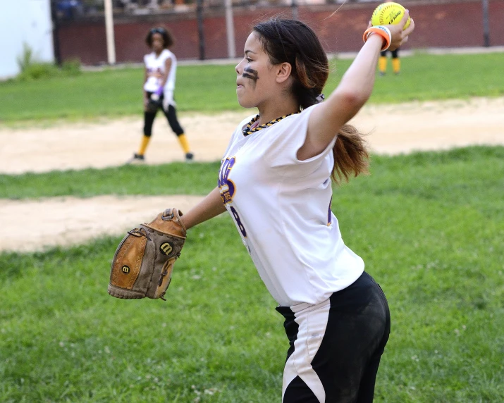  playing softball while the other young ones play in the back