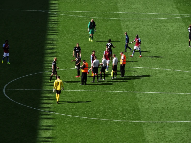 many people on a soccer field during the day