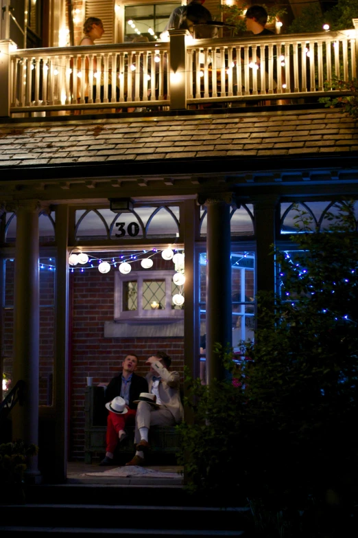 a porch decorated for christmas with holiday lights