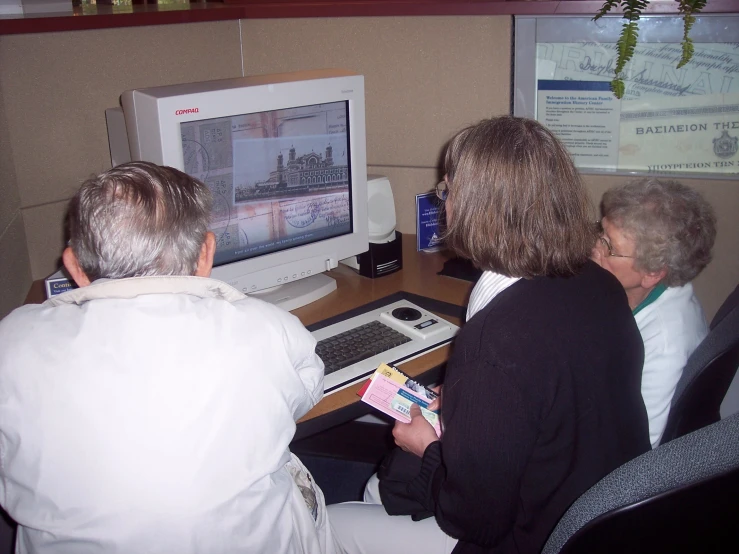 some people watching another person playing on a computer screen