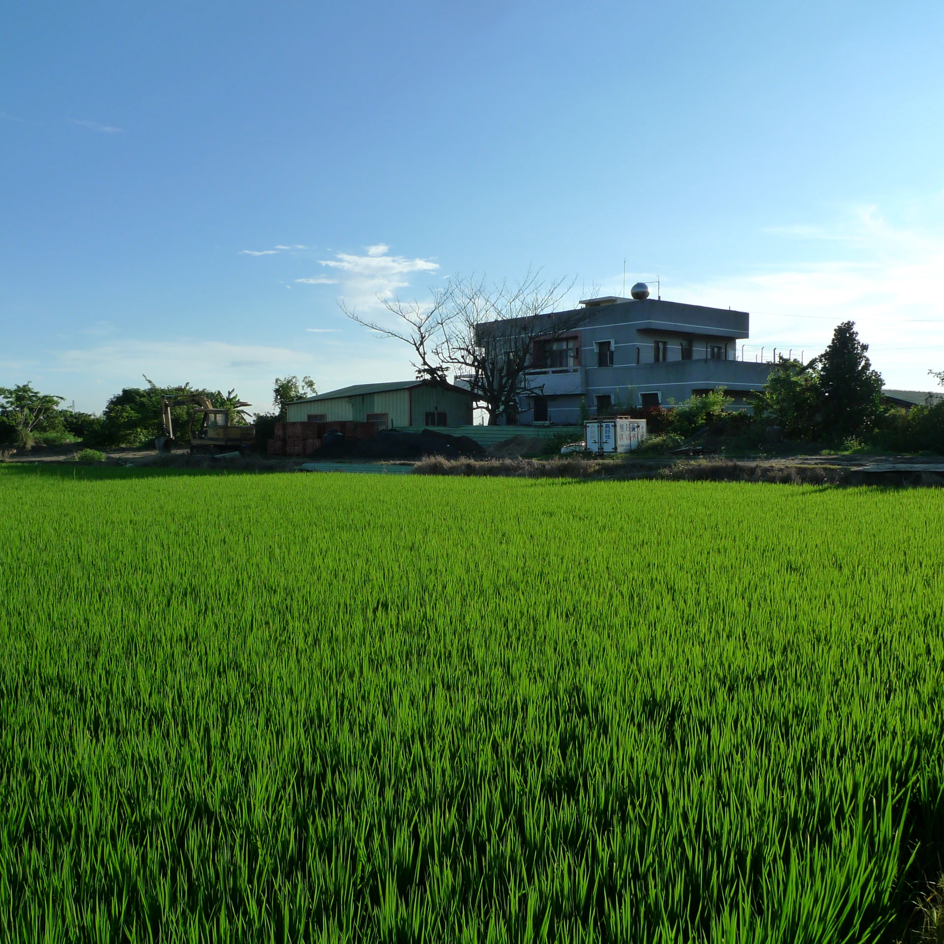 a large house and grassy field in front of it