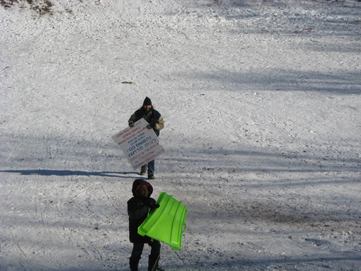 two people walking with a bright yellow kite