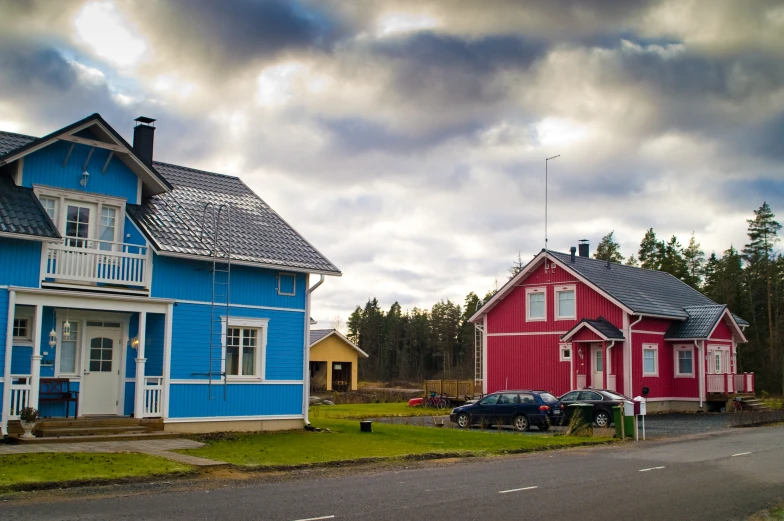 a group of small houses with a sky background