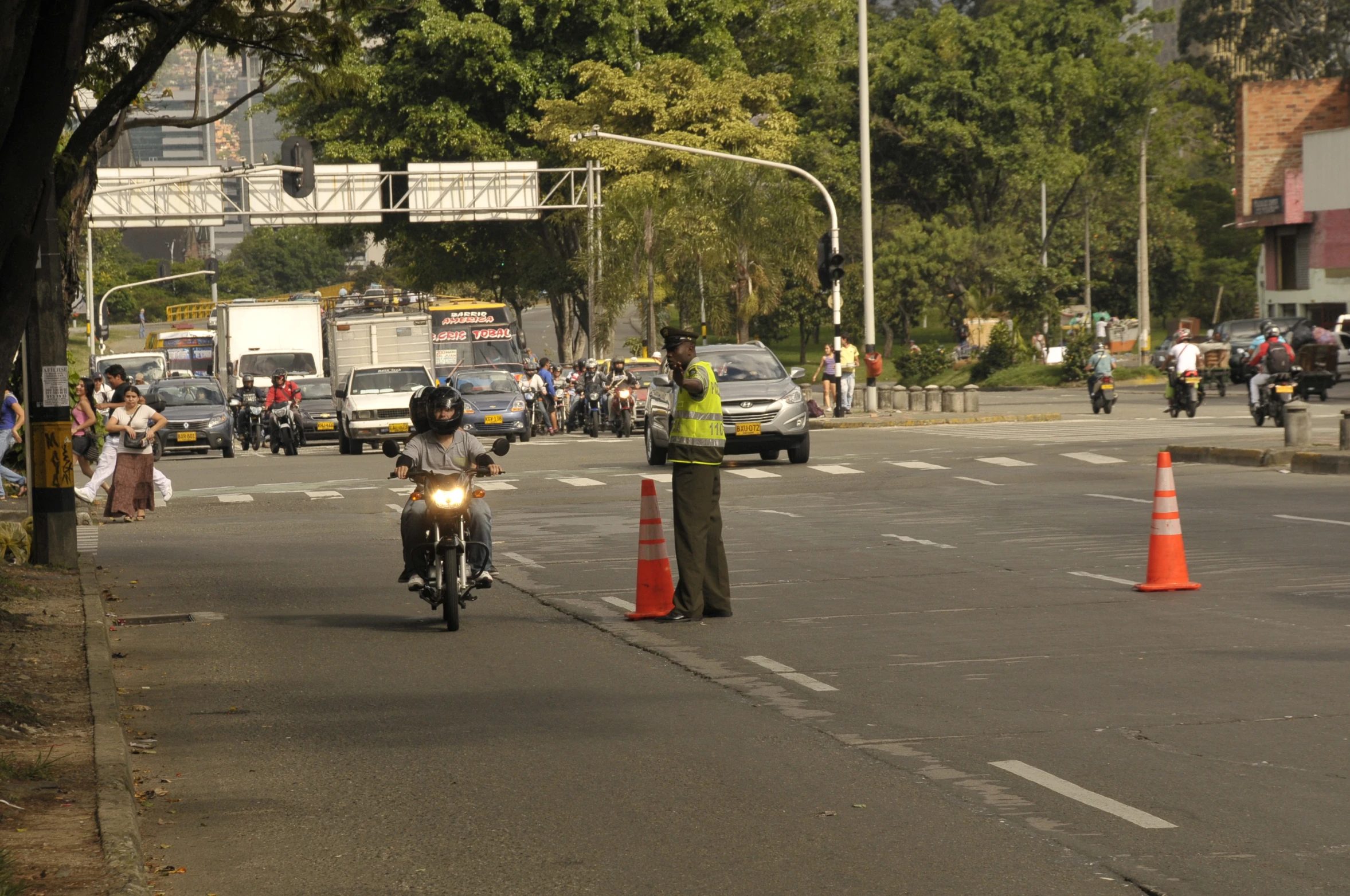 a man on a motor bike and traffic cones