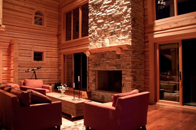 a living room with some red chairs and a table in it