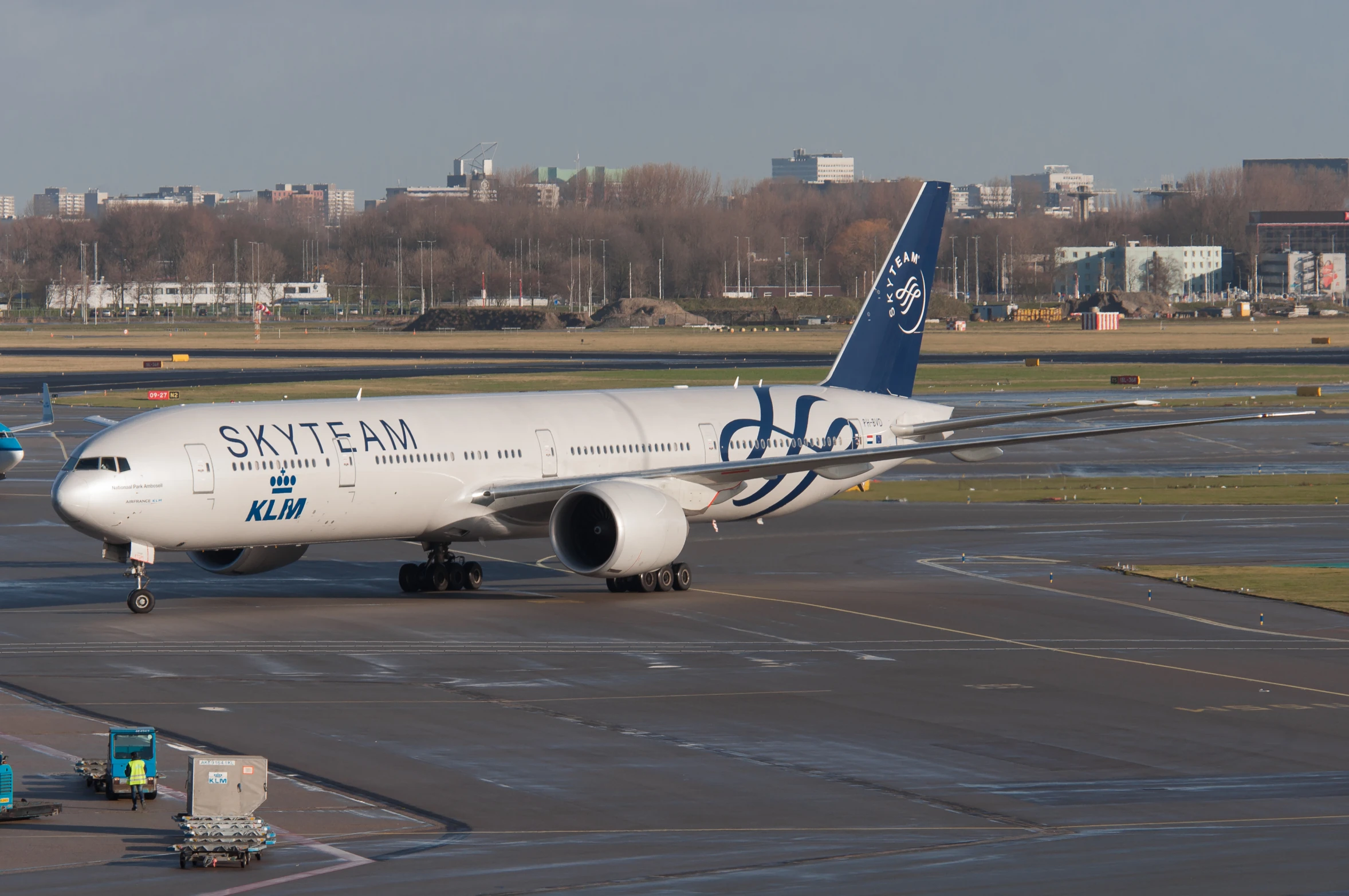 a large blue and white commercial jet on a tarmac