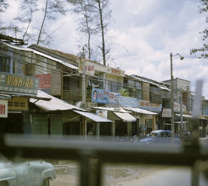 a building with signs is shown behind a gate