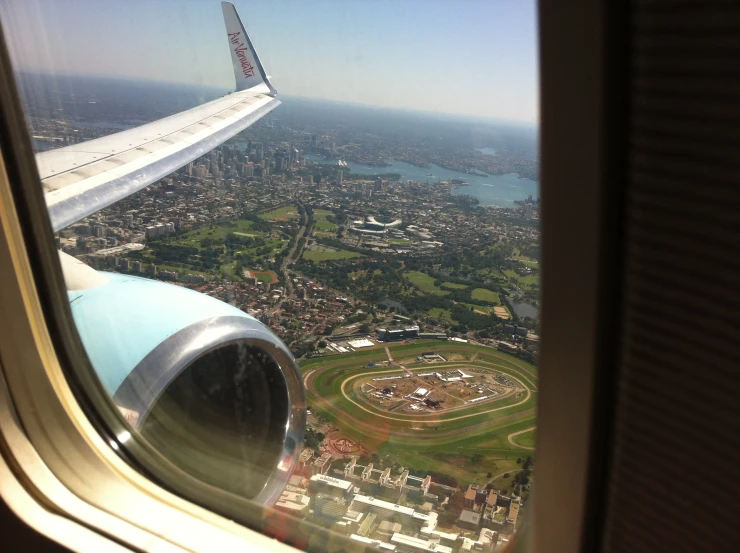 a view of an airplane wing, with a race track