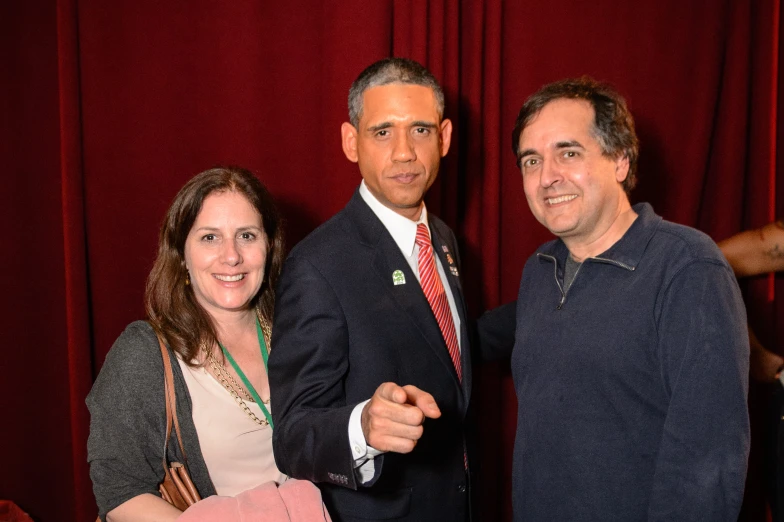 three people standing together for a po