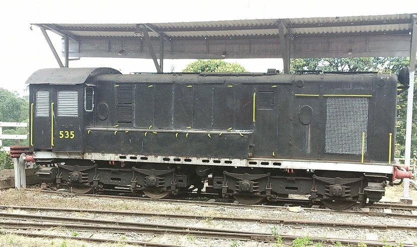 a train with two cars sitting next to each other on the tracks