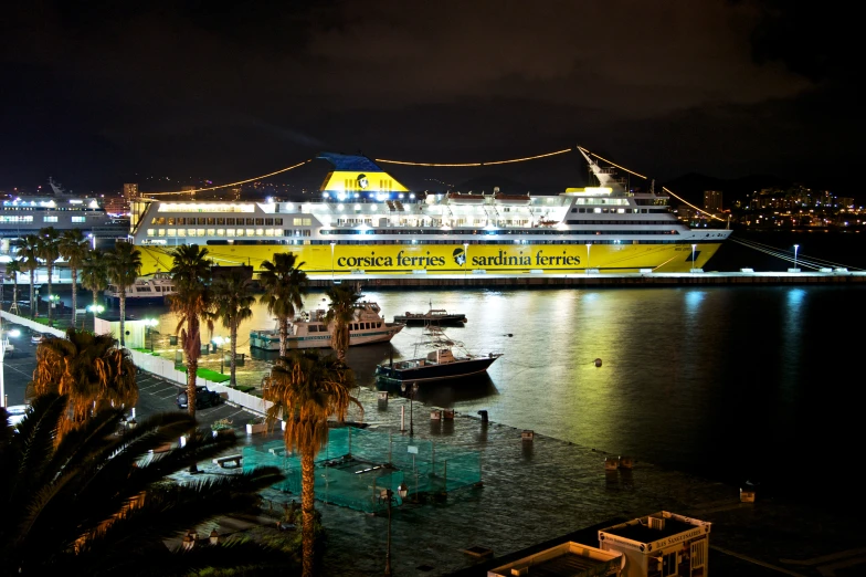 a large yellow cruise ship sits in the ocean