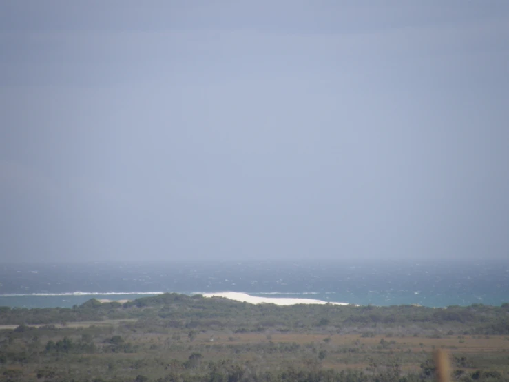 large, blue ocean sits on the horizon in the distance