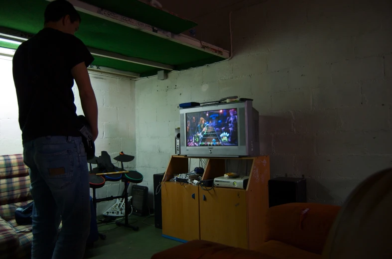 there is a young man playing a video game