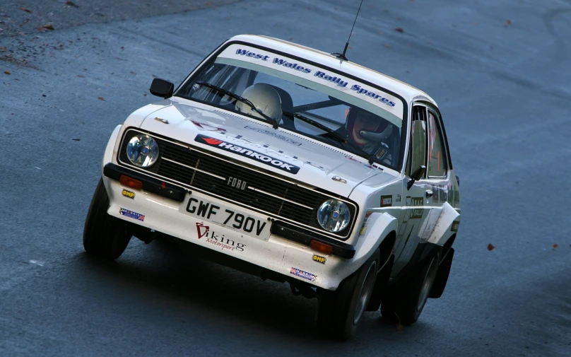 a car driving on a race track and pulling back a man