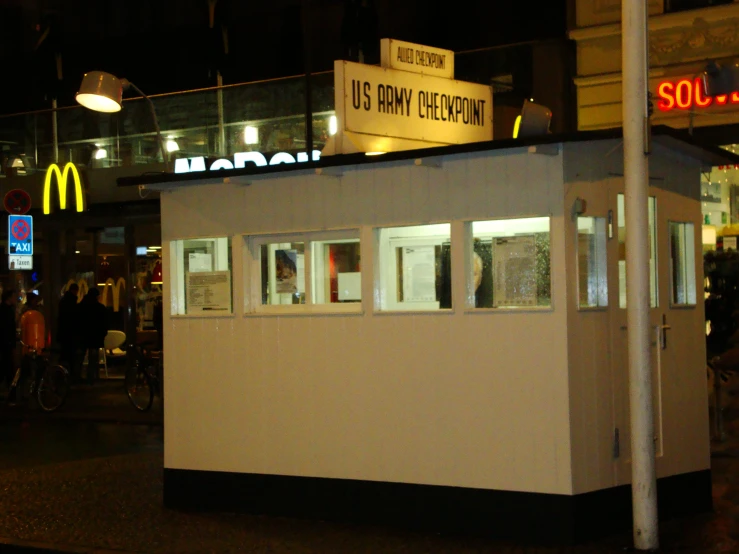 an empty mobile bar on the sidewalk in front of some mcdonalds