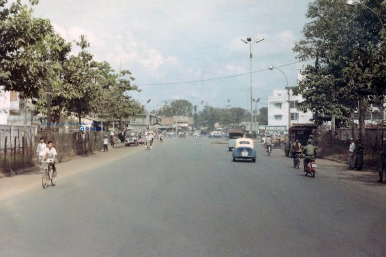 a street with cars and bicyclists on the road