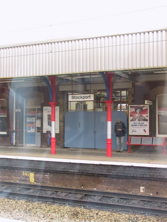 an old train station with a man standing on the platform