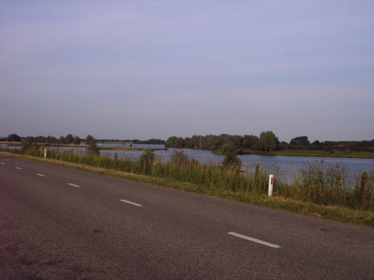 there is an empty street by the water