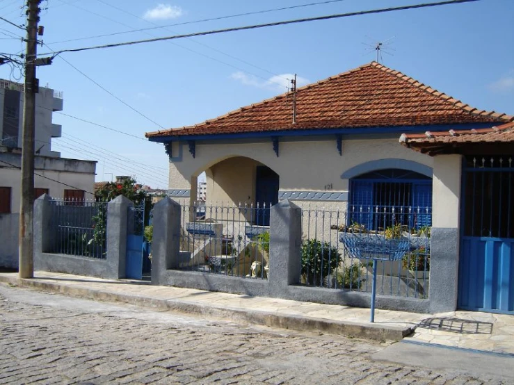 a home with a fence around it on a street