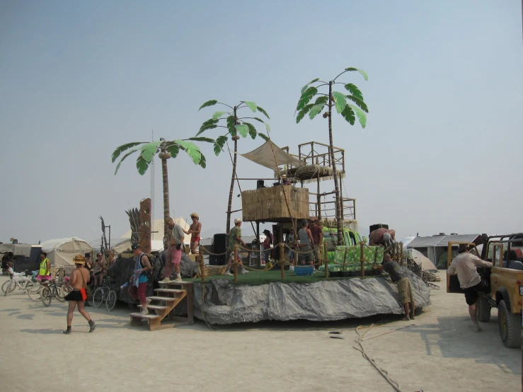 a group of people on the beach next to some palm trees