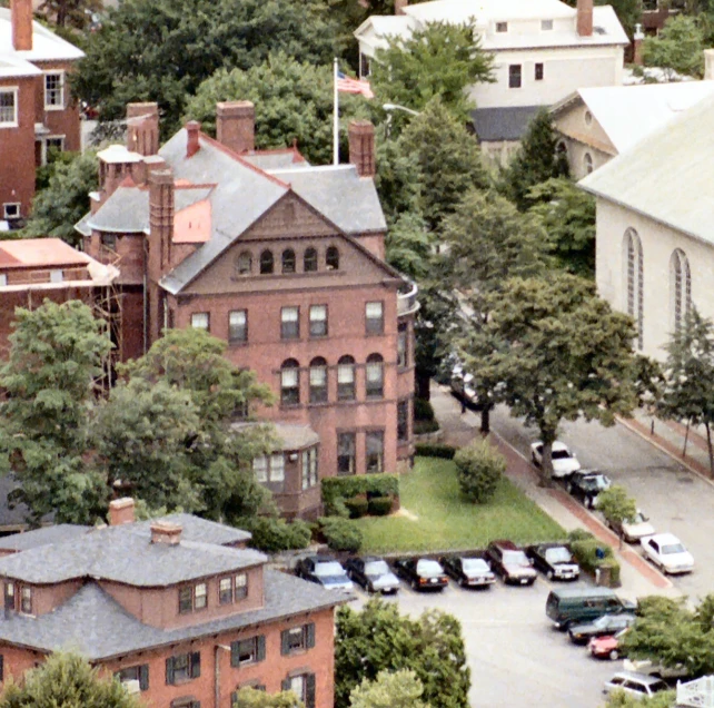 an overhead view of a building and other buildings in an urban area