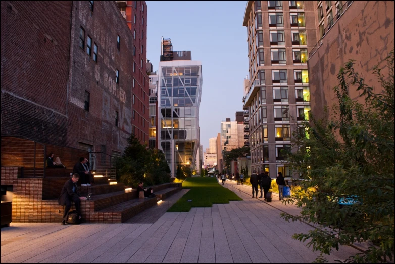 several people walking on the sidewalk by a building