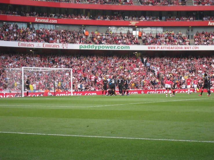 soccer teams on the field in front of a full stadium