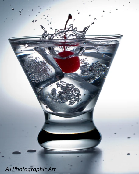 a martini glass with water and ice cubes