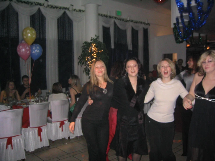 some women are posing for the camera in a party