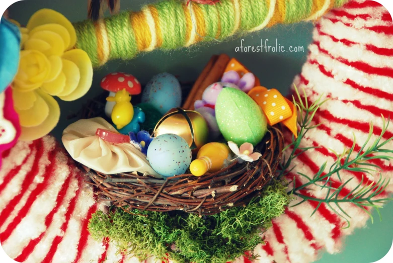 a group of fake colored eggs in a bird nest